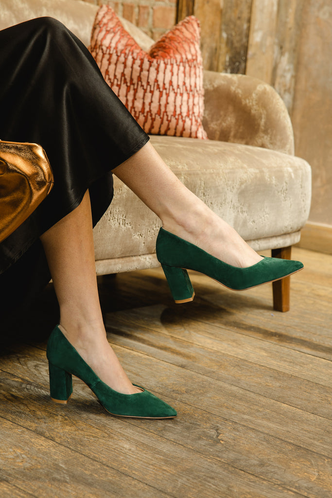 Person wearing green shoes in a living room setting