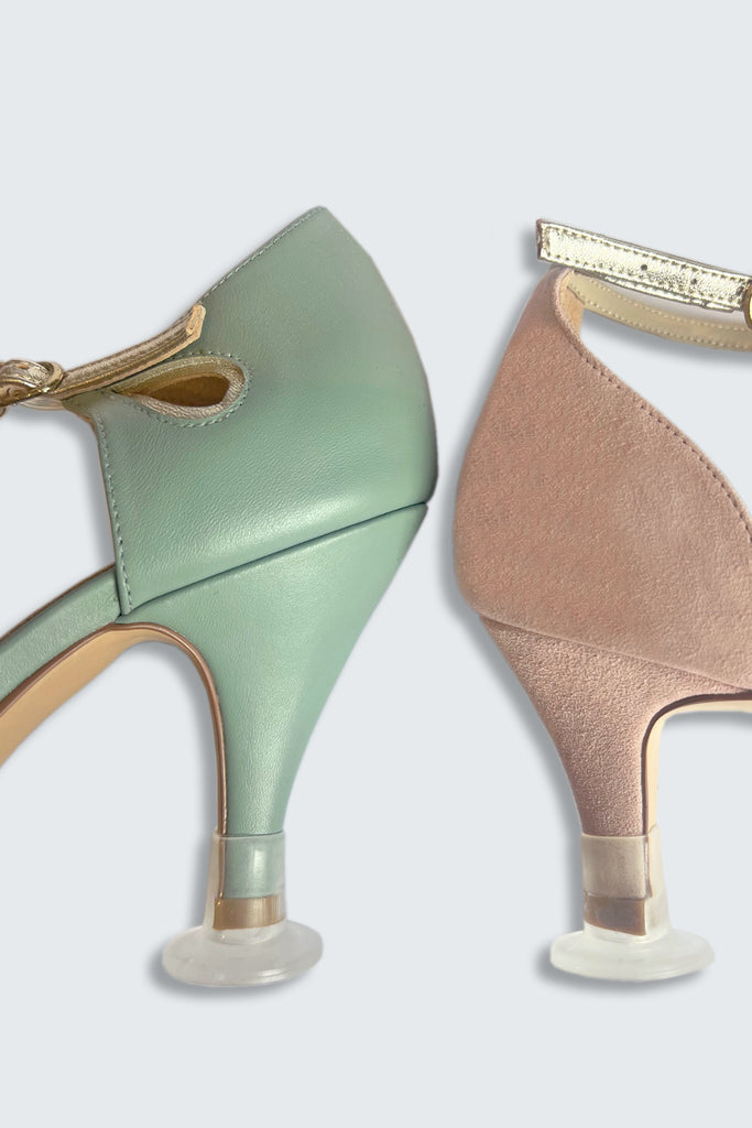 Green and beige high-heeled shoes with decorative straps on a light grey background with Clean Heels accessory
