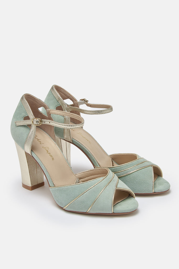 pair of mint green suede occasion shoes with gold block heel and ankle strap