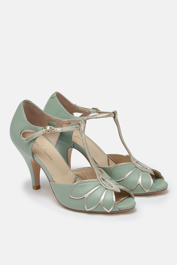 pair of mint green and gold leather t-bar occasion shoes with mid heels and ankle strap
