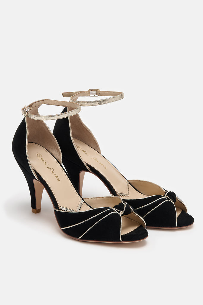 pair of black and gold suede occasion shoes with vintage inspired knot detail, mid heels and gold leather ankle straps