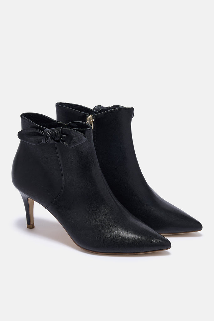 Black high-heeled ankle boots on a white background