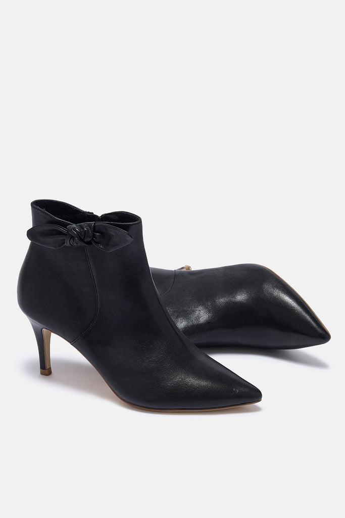 Black high-heeled ankle boots on a white background