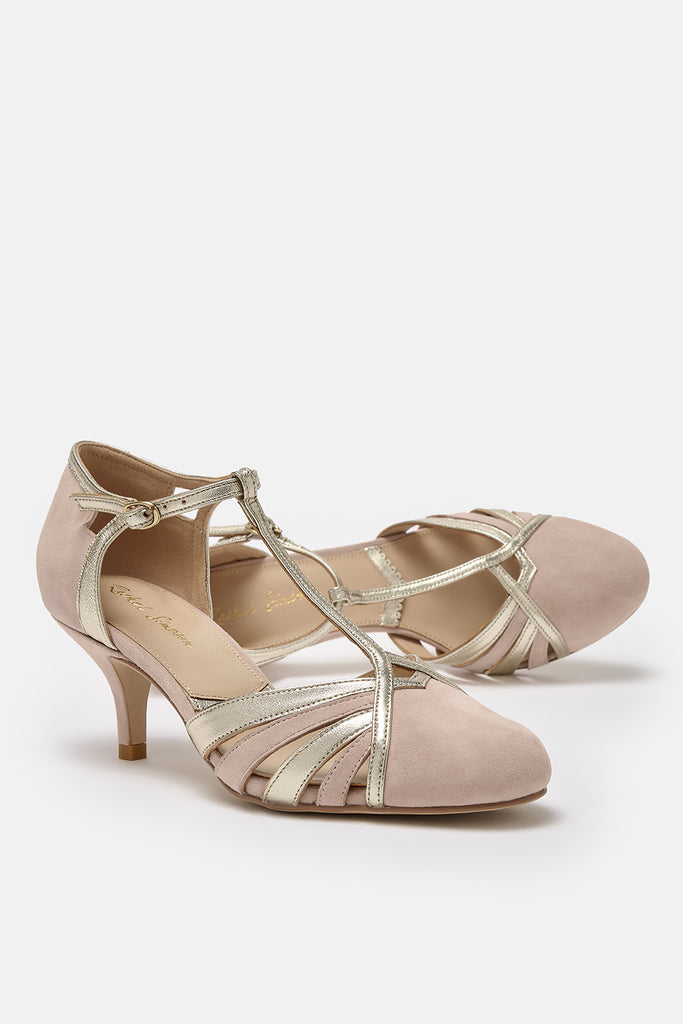 pair of blush pink suede and gold leather twenties vintage style t-bar occasion shoes, with low heels and ankle straps- one shoe is lying on its side