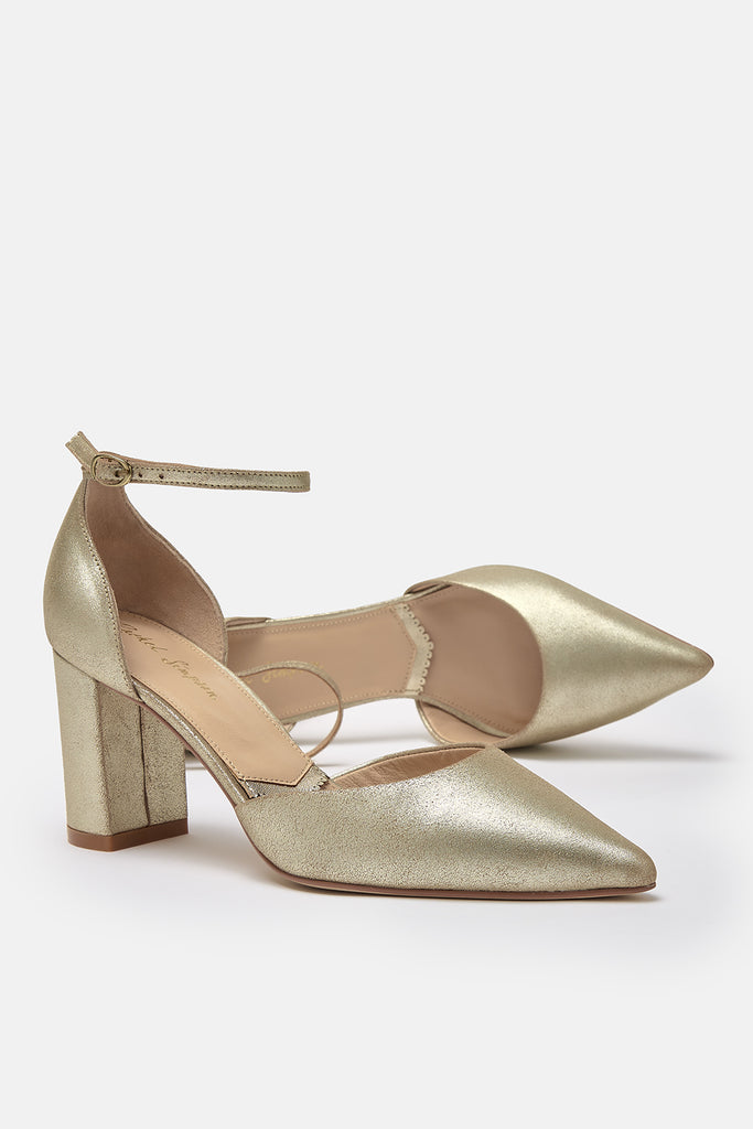 pair of antique gold leather two part pointed occasion shoes with block heels and ankle straps- one of the shoes is lying on its side
